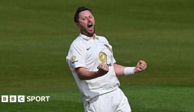 Ollie Robinson, wearing cricket whites, roars and punches both fists in celebration
