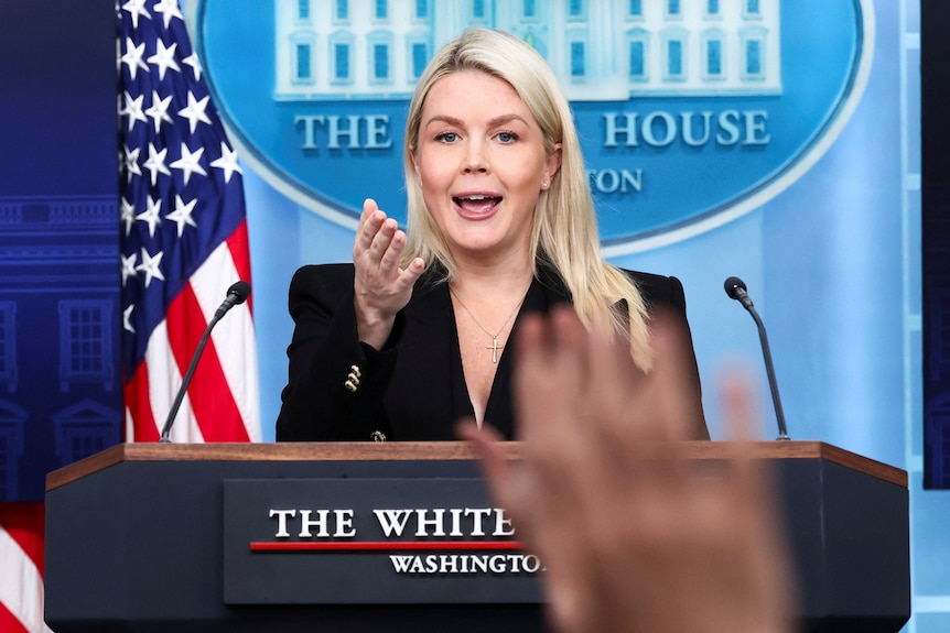 White House press secretary Karoline Leavitt takes questions from behind a podium.