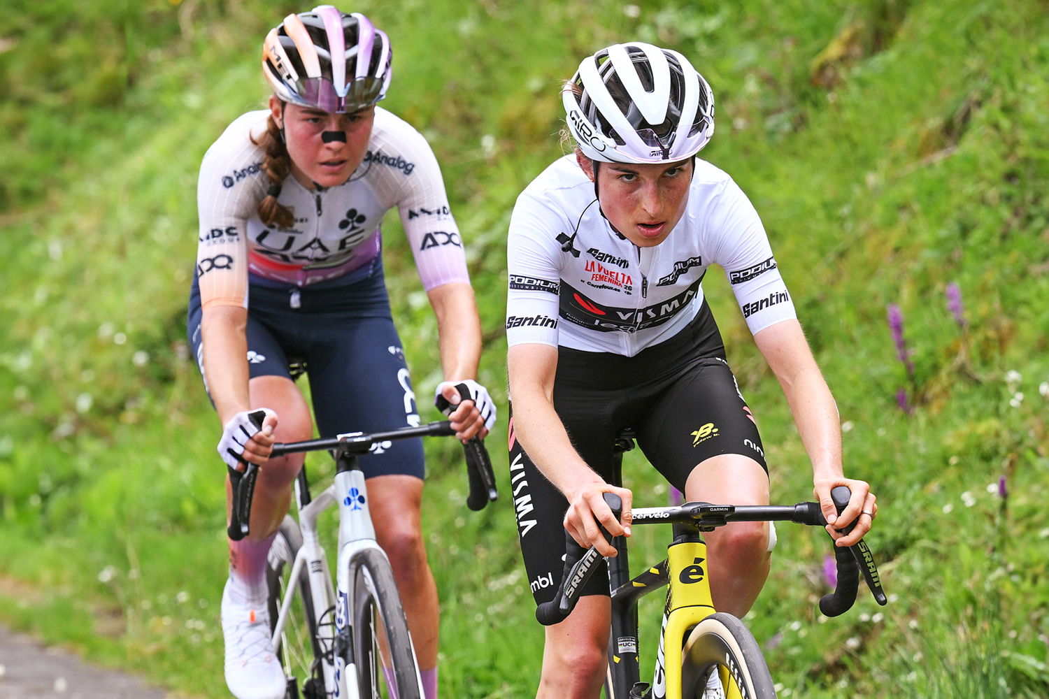 L'ANGLIRU, SPAIN - MAY 09: c(L-R) Paula Blasi of Spain and UAE Team ADQ and Marion Bunel of France and Team Visma | Lease a Bike - White Best Young Rider Jersey compete in the breakaway during the 12th La Vuelta Femenina 2026, Stage 7 a 132.9km stage from Pola de Laviana to L'Angliru 1555m / #UCIWWT / on May 09, 2026 in Pola de Laviana, Spain. (Photo by Szymon Gruchalski/Getty Images)