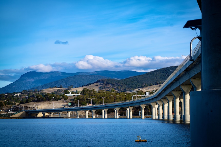 A photo showing the length of the new Bridgewater Bridge across the RIver Derwent with hills in the background.