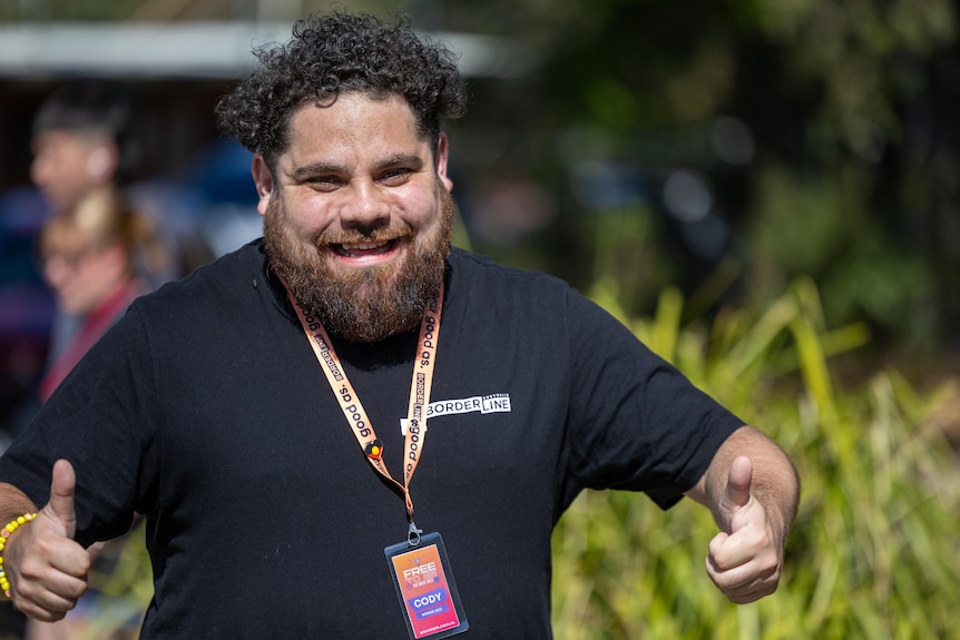 A man runs and gives the thumbs up