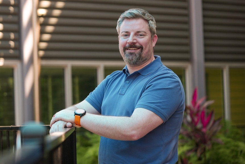 A bearded man in a blue polo shirt
