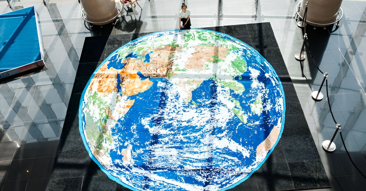 thousands of paper quills compose monumental mosaic earth artwork