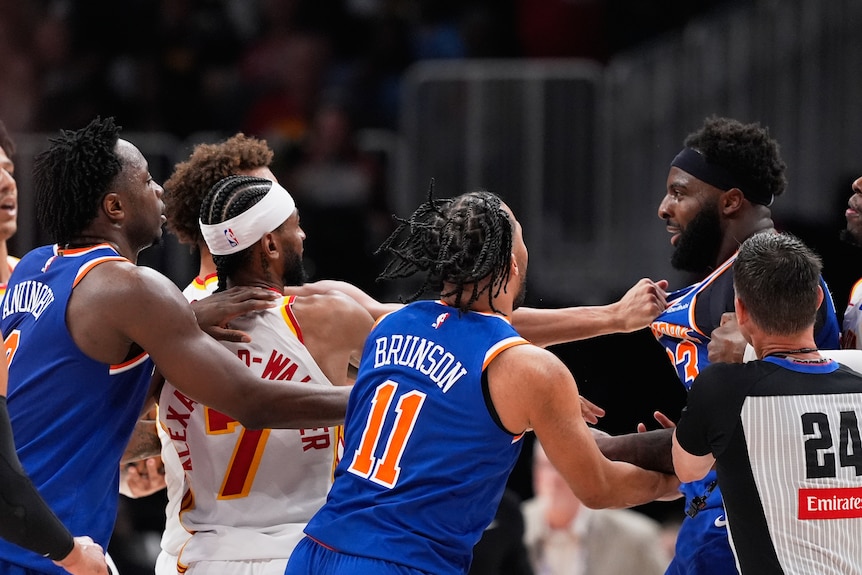 Knicks and Hawks players scuffle during an NBA game.