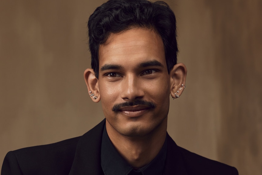 Shaneel Lal in a suit posing in a studio