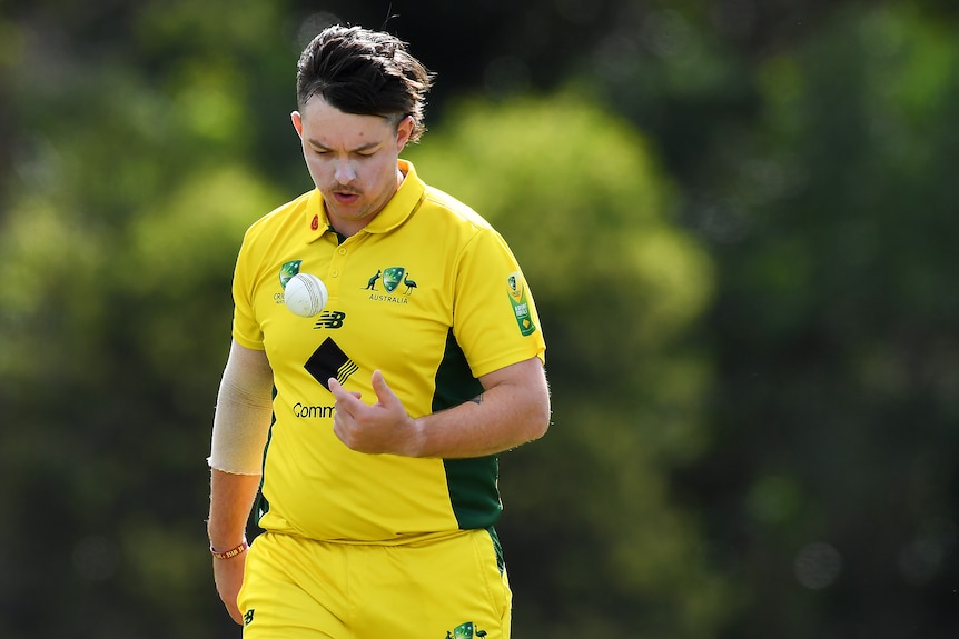 Callum Asbury, member of the Australian Deaf cricket team, throws the ball in the air as he prepares to bowl