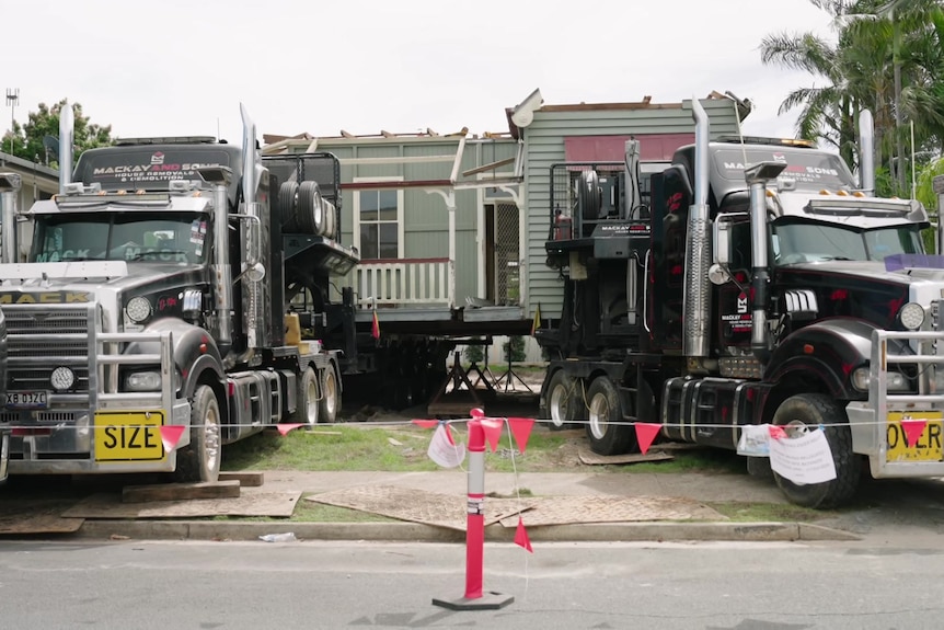 a roofless house on two trucks