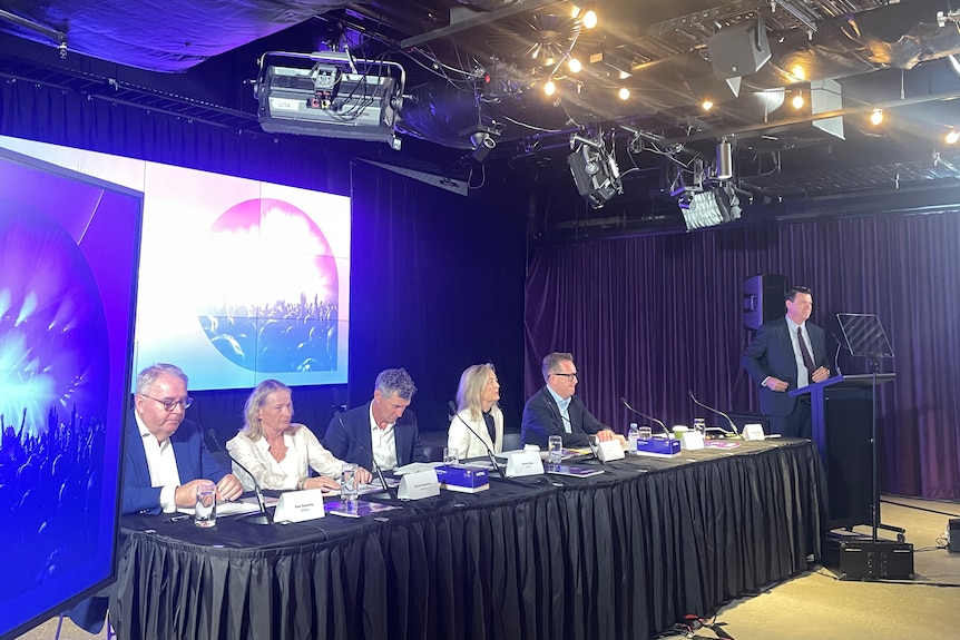 Inside ARN's annual general meeting where the board sits in front of the room.