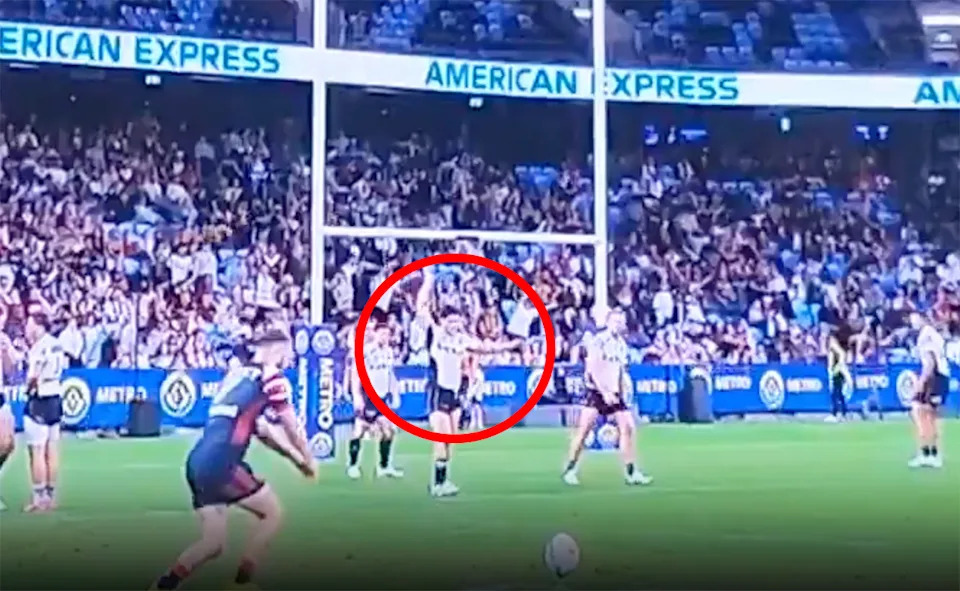 Ben Talty, pictured here waving his arms in the air while Sam Walker was kicking for goal.