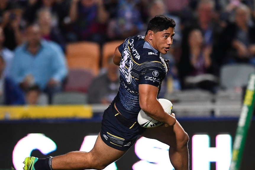 Jason Taumalolo runs the ball during a rugby league match.