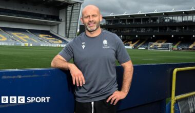 Worcester Warriors head coach leans on a hoarding at Sixways