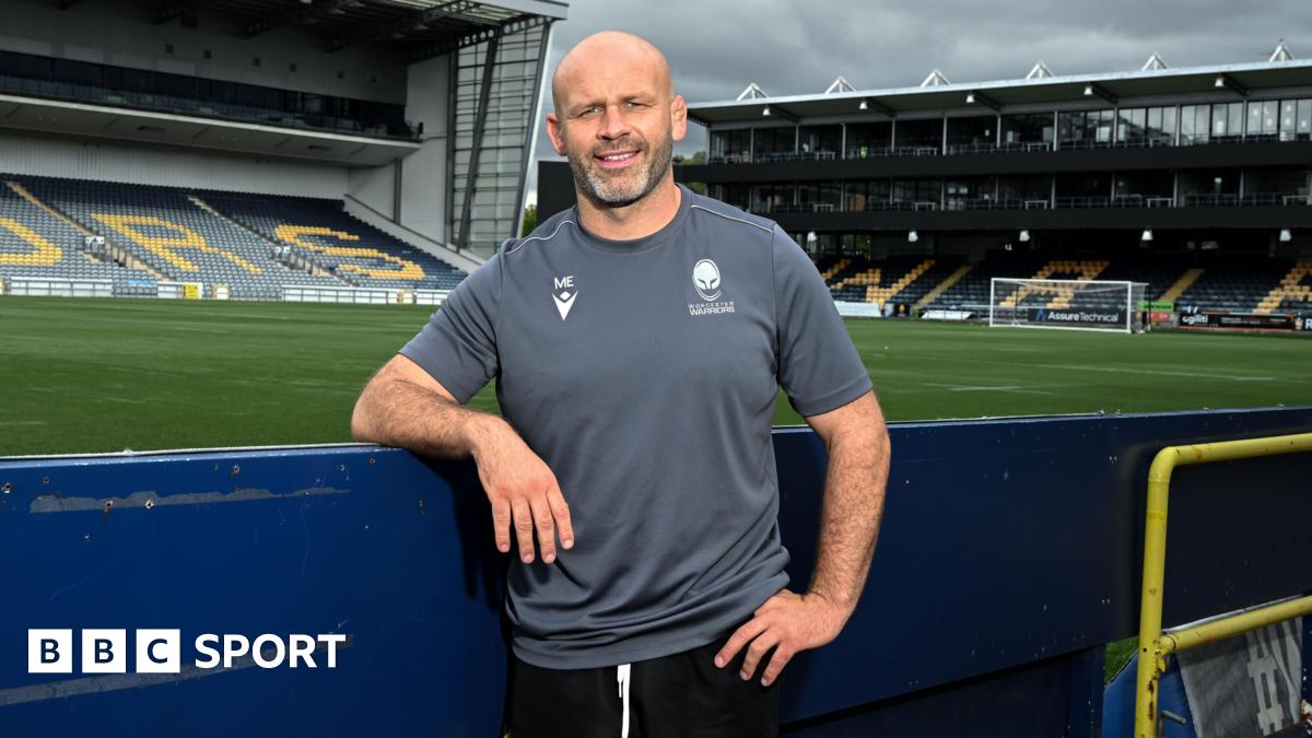 Worcester Warriors head coach leans on a hoarding at Sixways