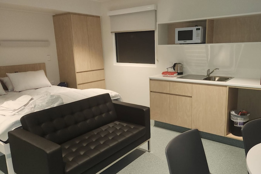 A self-contained room including a bed, couch and kitchen sink at the Bullsbrook COVID quarantine site.