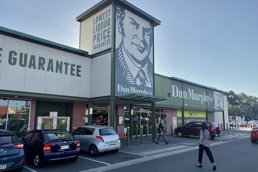 A woman walks into a Dan Murphy's store.