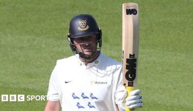 Ollie Robinson raises his bat after scoring a half-century for Sussex