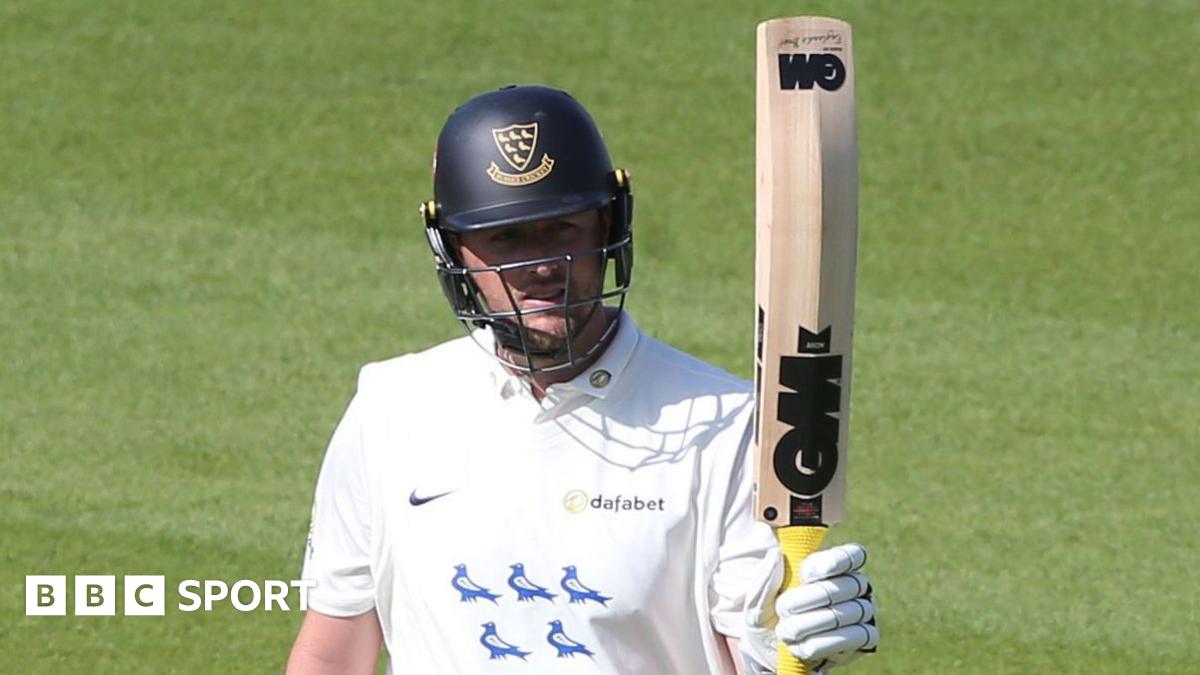Ollie Robinson raises his bat after scoring a half-century for Sussex