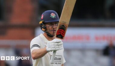 Luke Wells raises his bat to celebrate another 50 for Lancashire