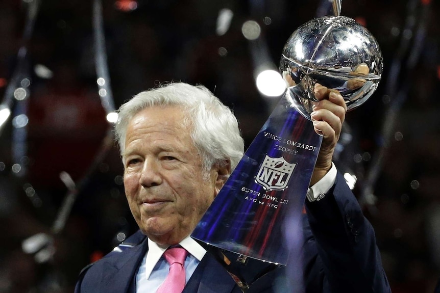 Robert Kraft holds up the Vince Lombardi trophy
