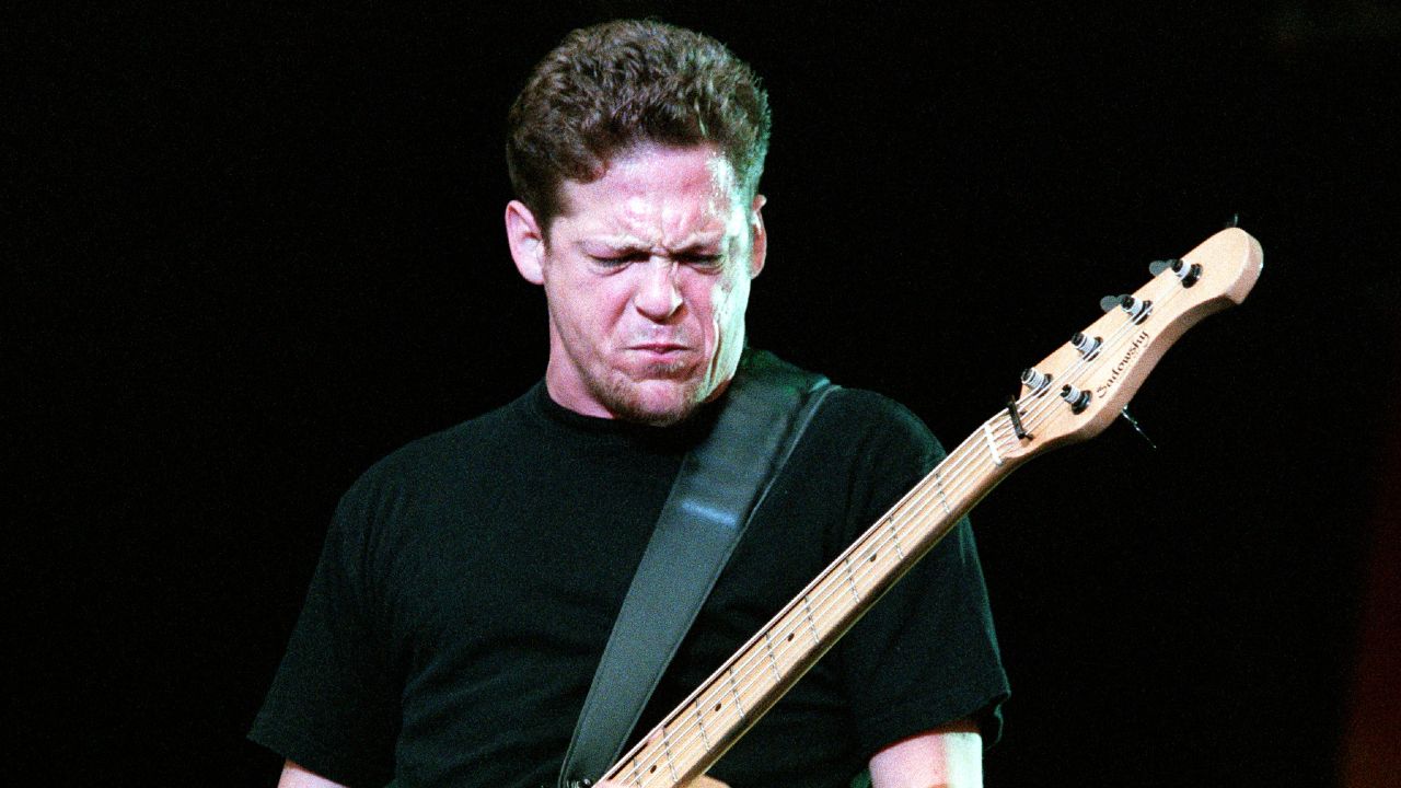 Jason Newsted performing onstage with Metallica in 1999
