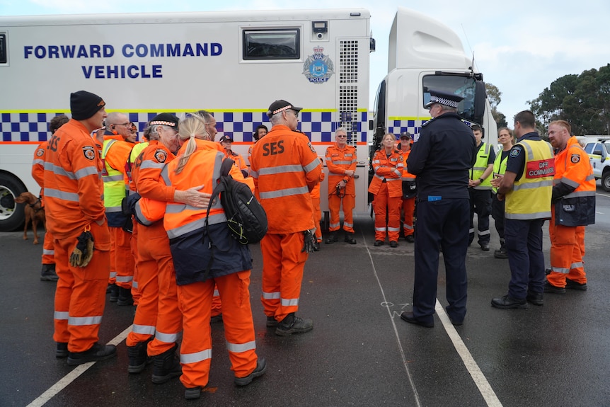People in bright orange SES uniform standing around 