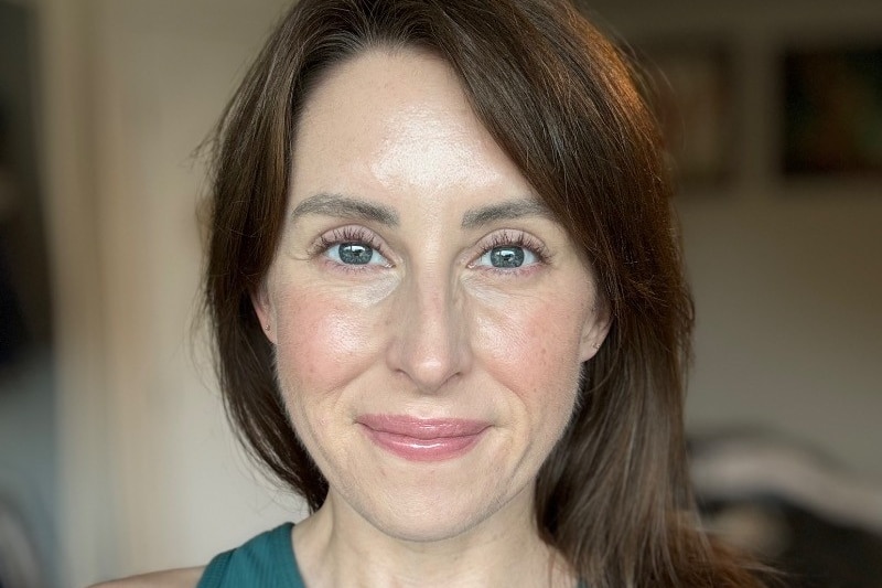 A head and shoulder image of a woman with long brown hair