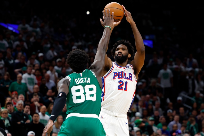 Joel Embiid shoots over Neemias Queta in Game 7