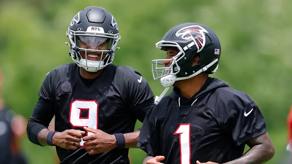 QBs Michael Penix Jr. and Tua Tagovailoa are competing for the same starting job. Photo by Todd Kirkland on Getty Images