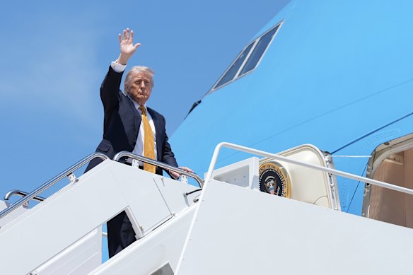 President Donald Trump waves from the stairs of Air Force One on his way to China to meet President Xi Jinping.