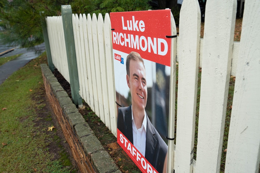 A picture of a Labor party election sign for Luke Richmond on a white fence.