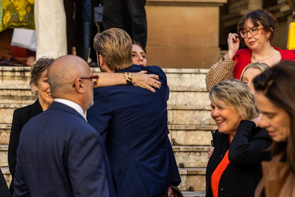 James Valentine’s wife Joanne Corrigan (centre) and daughter Ruby (right) leave the celebration of his life at Sydney Town Hall.
