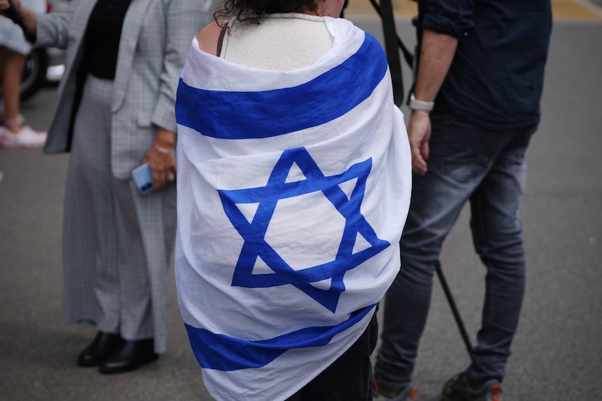 A woman wearing an israeli flag.