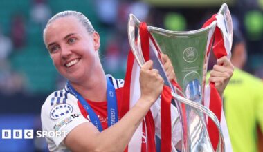 Arsenal forward Beth Mead holding the Women's Champions League trophy