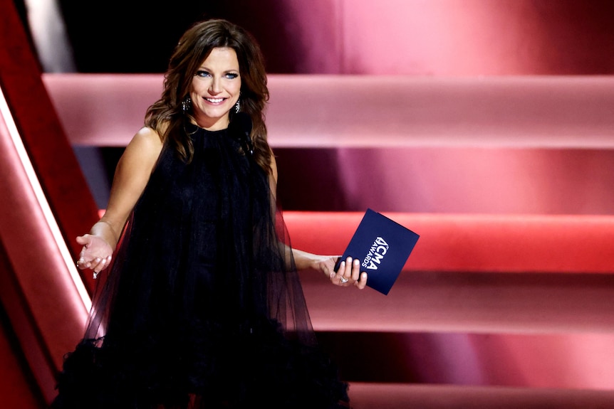 Martina McBride appears onstage in a black dress