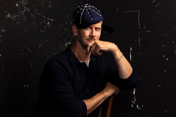 Writer Damien Woolnough wearing an evening headpiece in the beret style from Somewhere Here Now.