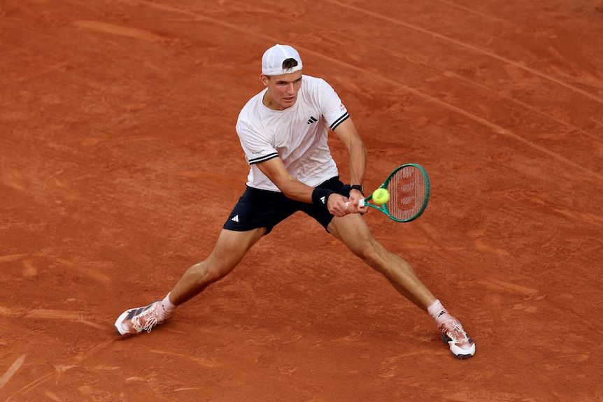 Jakub Mensik plays a two-handed backhand on clay court