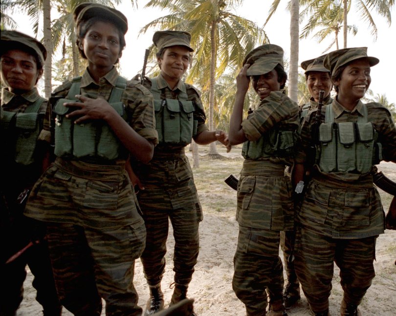 TAMIL TIGERS (female fighters) training at Jaffna Peninsula, Sri Lanka.They are on manouevres through the bush. The girls are feared just as much as the men by the government forces. No shortage of smiling faces. PICTURE: TONY ASHBY / STORY: NORMAN AISBETT for Weekend Extra. Picture: Tony Ashby