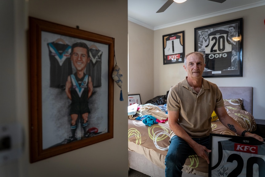 An Adelaide resident at his suburban home, surrounded by Port Adelaide paraphernalia.