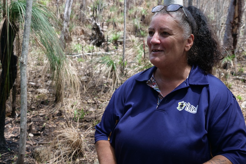 Aunty Deb Clark standing in recently burnt forest at Cape Hillsborough. 