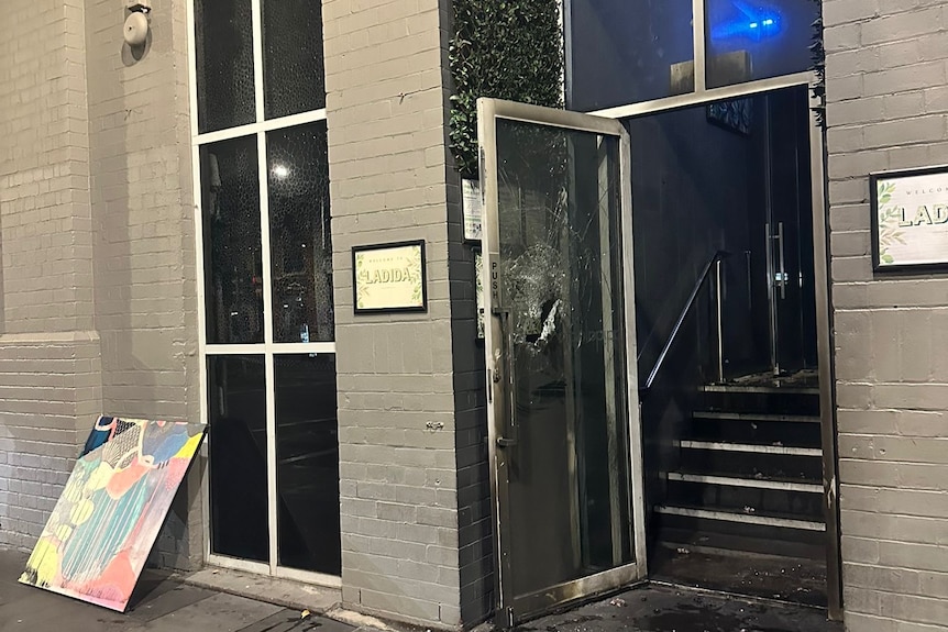 A smashed door of a nightclub.