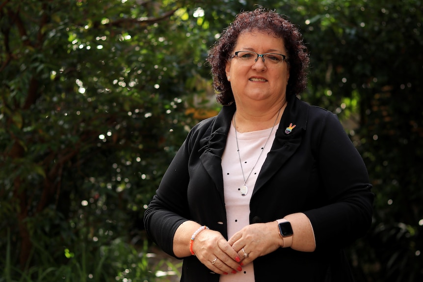 A woman in spectacles and a business suit