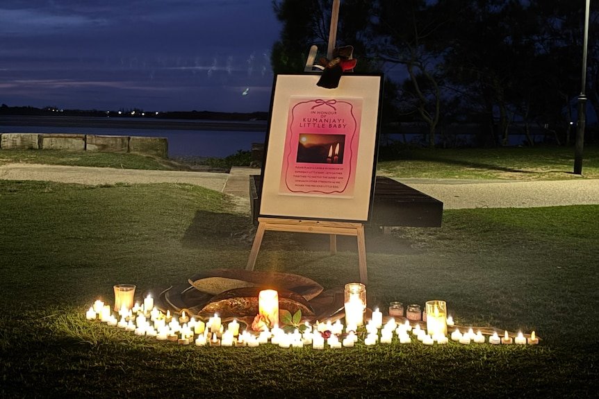 An easel and candles at dusk.