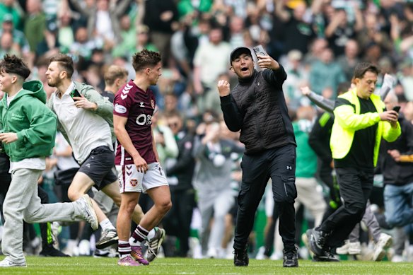 Cammy Devlin is accosted by a selfie-hunting Celtic fan at full-time.