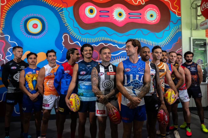 First Nations representatives pose in Indigenous jerseys