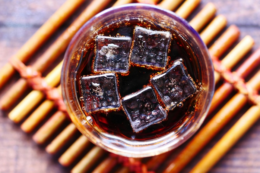 Glass of soft drink with ice, from above
