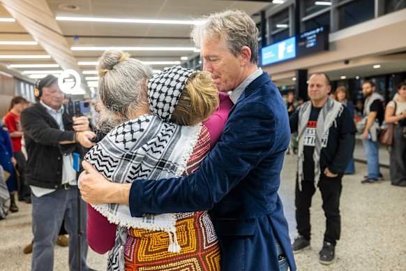 Gemma O’Toole, middle, hugs her parents Dr Suzie O’Toole and Dr Patrick Keyzer, after arriving home in Melbourne on Sunday night.