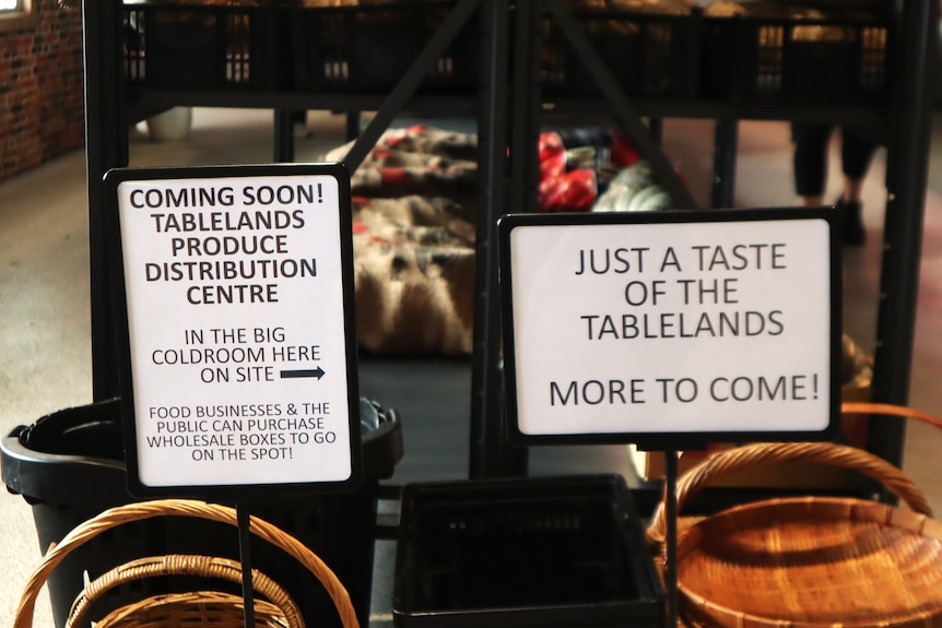 Tow signs inside a produce store in Cairns.