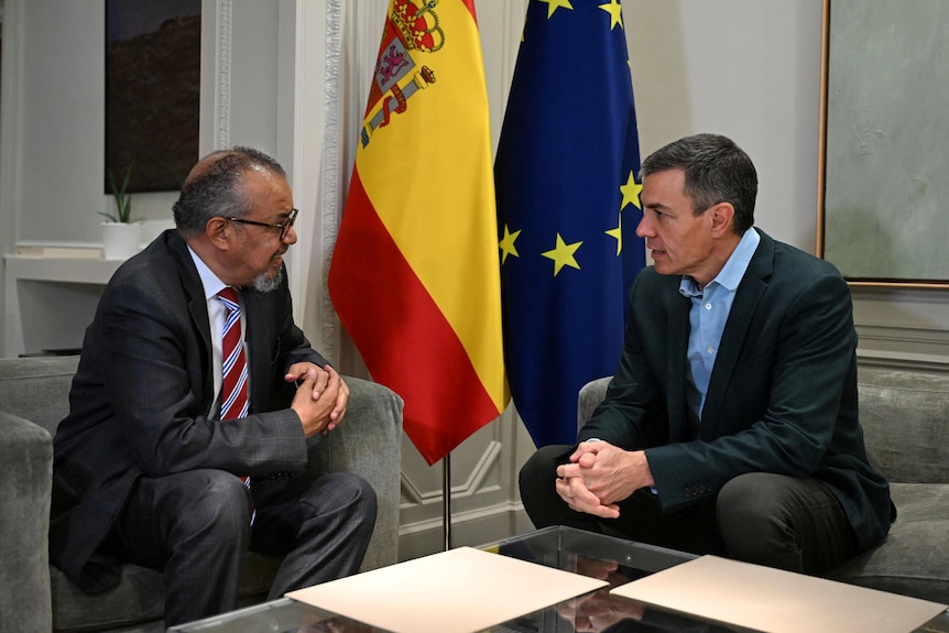 WHO Director-General Tedros Adhanom Ghebreyesus talks with Spain's Prime Minister Pedro Sanchez.