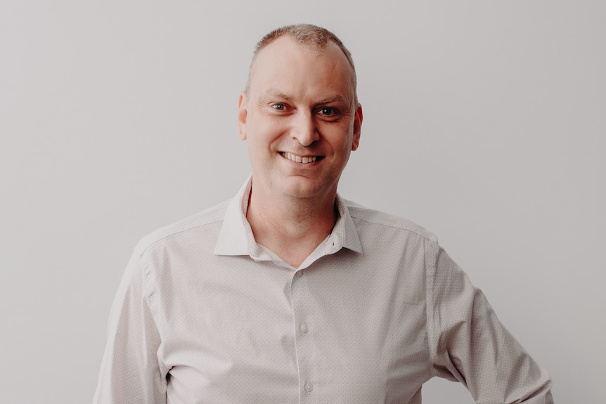 image of man smiling in a business shirt