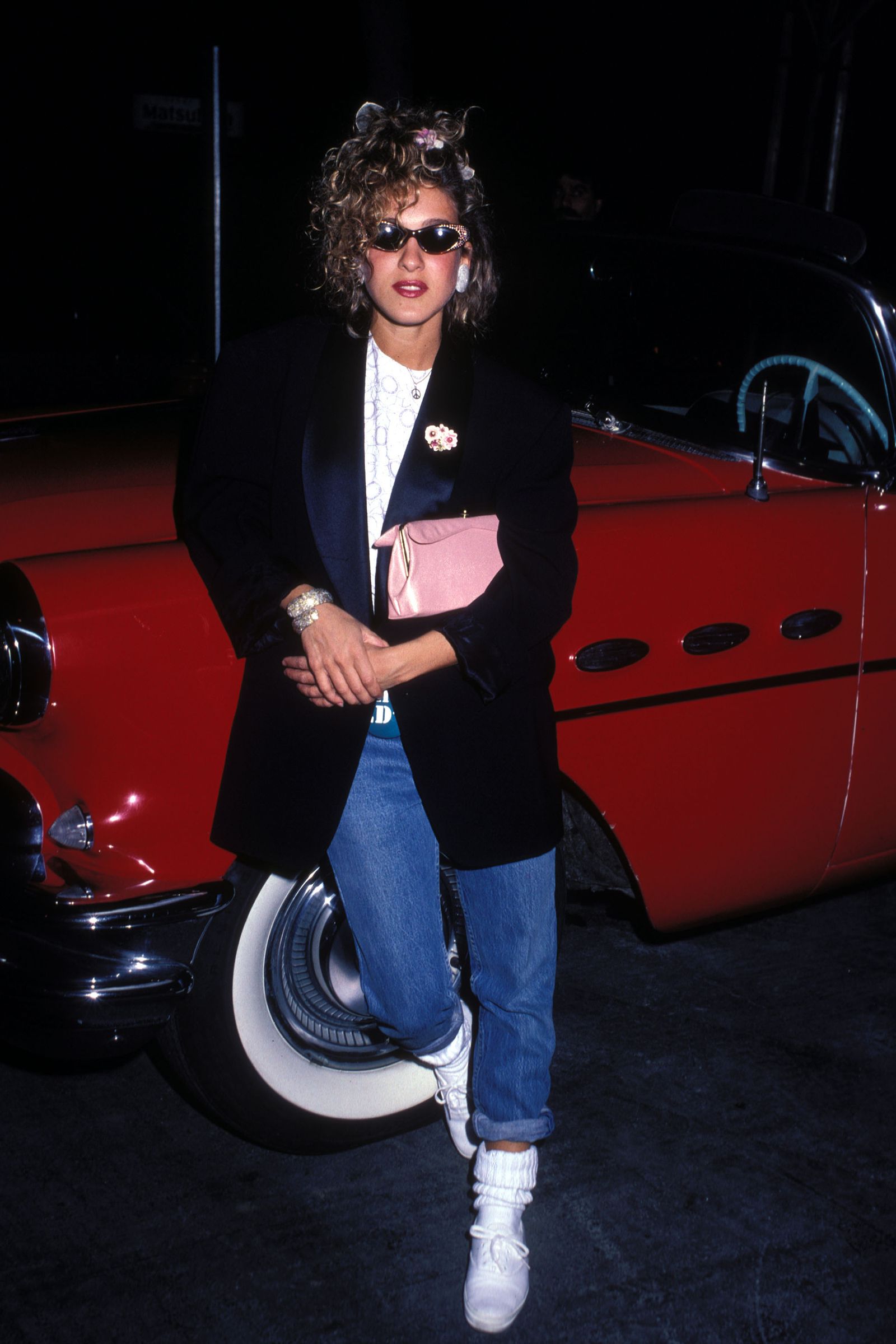 Image may contain Sarah Jessica Parker Clothing Coat Jacket Pants Blazer Face Head Person Photography and Portrait