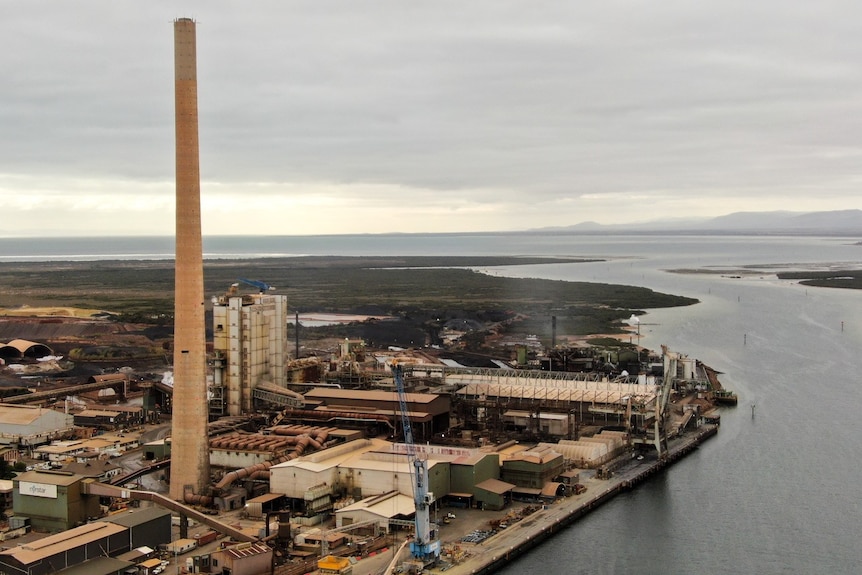 A metal smelter facility by the water.